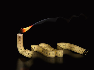 The concept of burning life and the remaining time. Measuring tape burns like a candle