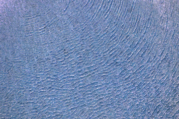 blue water background ripples in a swimming pool
