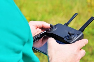 Man holds a drone remote control panel. outdoor, selective focus. Drone control panel in the hands...