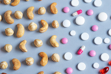 abstract background of nuts and pills. Healthy eating concept.
