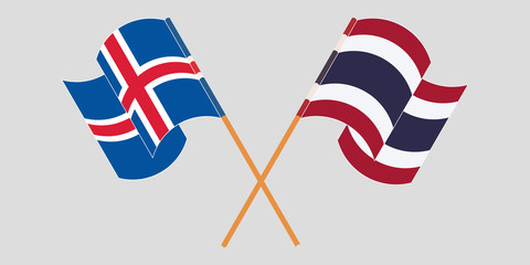 Crossed and waving flags of Iceland and Thailand
