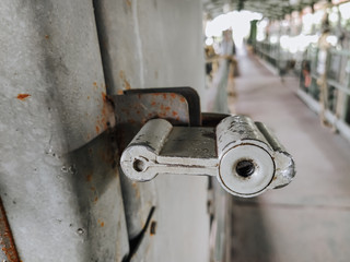 A metal old rusty lock with a keyhole hangs on a door, a gate. Photography, concept.
