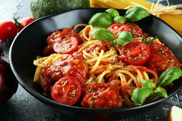Tasty appetizing classic italian spaghetti pasta with tomato sauce, cheese parmesan and basil and ingredients