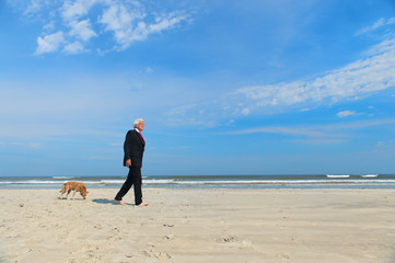 Business man with dog at the beach