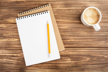 Notebook with pencil and coffee cup.