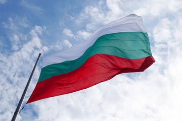 Fototapeta na wymiar Bulgaria flag waving in the wind against sky