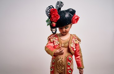 Young little caucasian kid girl wearing  bullfighter traditional folkore spanish suit as carnival...