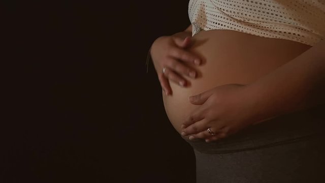 Caress on the belly - Pregnancy - Pregnant - Blak Background