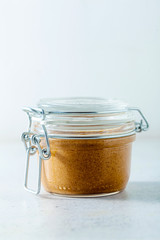 homemade sesame seed tahini spread sauce in a sealed jar on the table