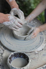 Lots of hands on a potter's wheel - master class for children and adults