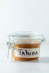 homemade sesame seed tahini spread sauce in a sealed jar on the table