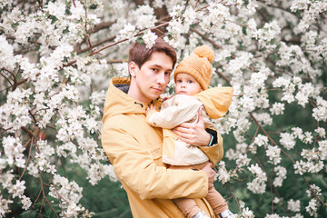 father and son in a lush garden next to Apple trees