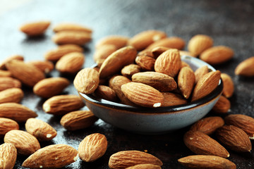 Almonds on a rustic background and almond in bowl.