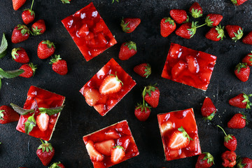 strawberry cake and many fresh strawberries on rustic background table