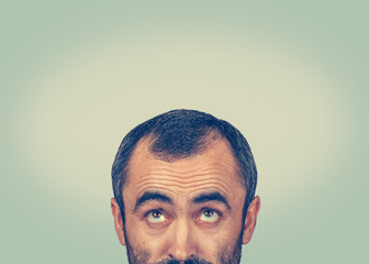 Headshot confused man thinking looking up