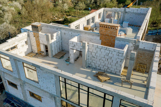 Building site of a house under construction made from white foam concrete blocks. Building new frame of home