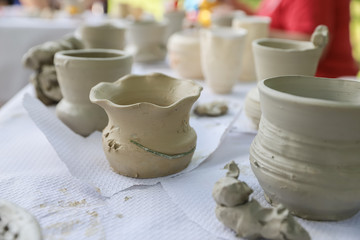 Fototapeta na wymiar Handmade clay products: vases, pots, jars and plates