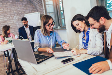 Young couple signing a contract  on a meeting with investment agent in the office.