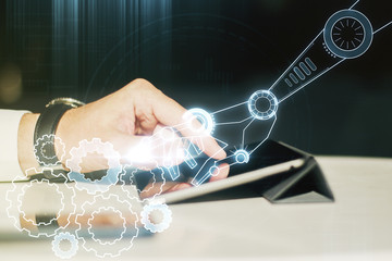 Double exposure of robotics technology hologram and finger clicks on a digital tablet on...
