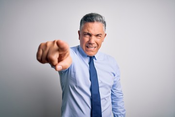 Middle age handsome grey-haired business man wearing elegant shirt and tie pointing displeased and frustrated to the camera, angry and furious with you