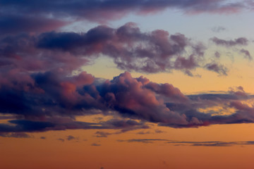 dramatic textured clouds at sunset yellow red tones
