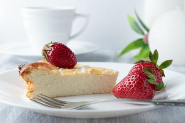 Breakfast with cheesecake, strawberries and a cup of tea.