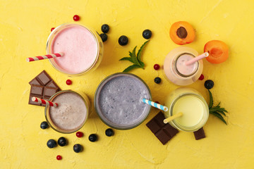 Fototapeta na wymiar Delicious milkshakes on yellow background. Summer drink