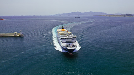 Aerial drone photo of passenger ferry reaching destination - busy port of Piraeus, Attica, Greece