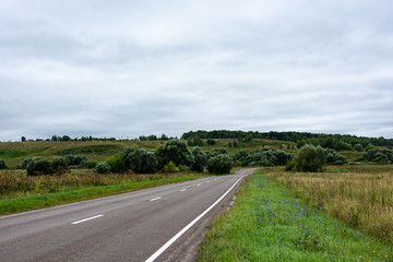 Fototapeta premium Landscape with an asphalt road in the countryside.