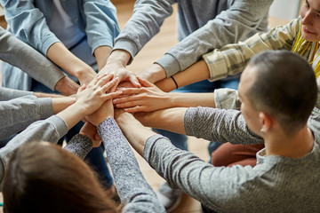 cropped photo of unrecognizable people hands gathered in one. anonymous alcoholics club team, fight with alcohol addiction