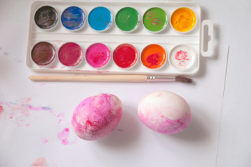 Two boiled eggs painted into pink color