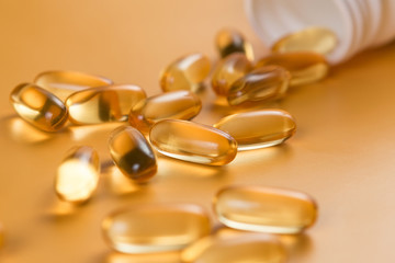 Many capsules Omega 3 on yellow background. Close up, high resolution product. Health care concept.