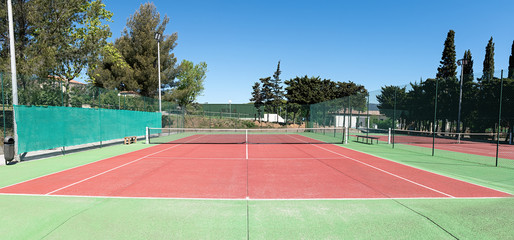 Tennis court playing surface and net