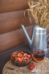 Tiny pancake cereal mini pancakes in a wooden bowl with strawberries on a wooden background. Top view. Copy space