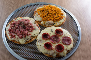 Mini pizza of various flavors. Brazilian snack