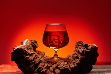 glass of whiskey on wooden table , red tint atmosphere, time of relax with whisky