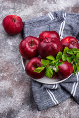 Fresh red ripe apples on gray background
