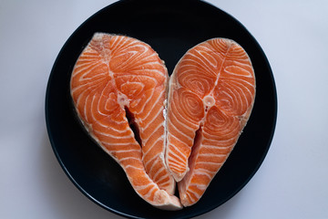 Fresh Raw Tasty Big Textured Salmon Steak in shape of heart in Macro Shot. Fish cooking concept. Healthy Diet Food. Love Seafood