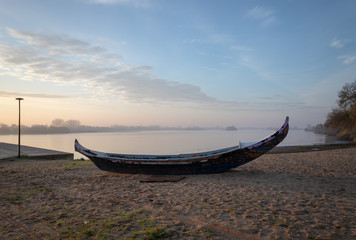 old boat on the river beach on top of the sand by the river