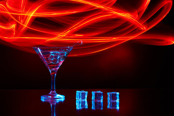 Neon martini glass shot with long exposure. Red club lights.