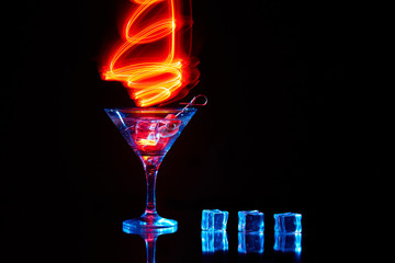 Neon martini glass shot with long exposure. Red club lights.