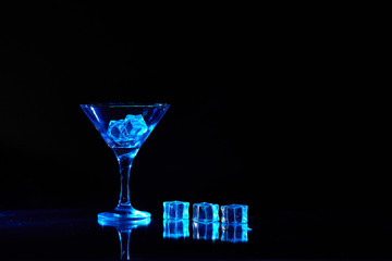 Martini cocktail drink splash with ice cubes in neon iridescent . Minimal night party life concept.