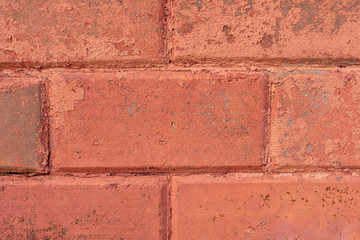 wall of old orange tiles and bricks. orange background. cracks, scratches and chips on an empty surface.