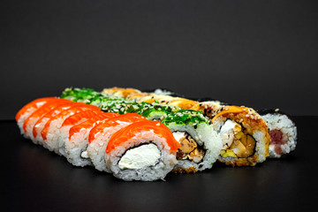 Large set of Delicious sushi rolls. A lot assortment Philadelphia roll Dishes from Japanese raw fish. Japan food menu service