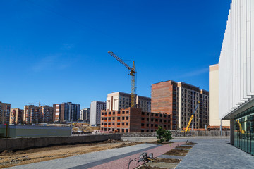 Extensive scaffolding providing platforms for work in progress on a new apartment block,Tall...