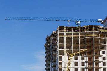 Extensive scaffolding providing platforms for work in progress on a new apartment block,Tall...