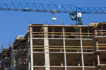 Extensive scaffolding providing platforms for work in progress on a new apartment block,Tall...