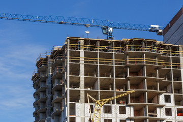 Extensive scaffolding providing platforms for work in progress on a new apartment block,Tall...