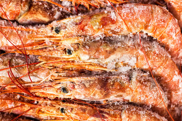 Obraz na płótnie Canvas Fresh red shrimps or prawn packing in box on slate stone background. Seafood, top view, flat lay, copy space