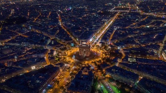 flight over paris city center night time triumph arch traffic circle street aerial timelapse panorama 4k france